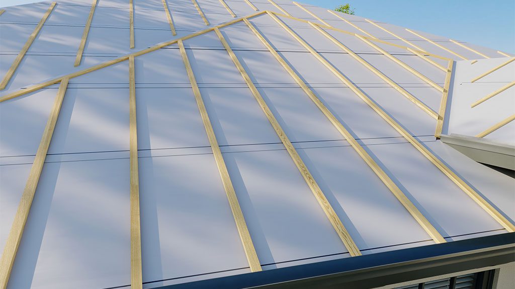 A modern roof with diagonal wooden battens over light gray metal panels against a blue sky.